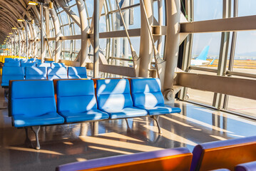 Airport terminal glass window with view of airplane, airport interior departure hall for travel and transportation concept.
