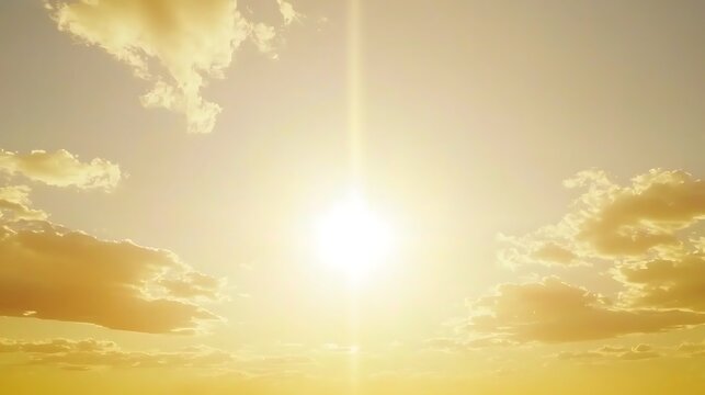 A glowing golden hour sky with the sun casting rich golden and amber tones, gently illuminating faint, scattered clouds across the sky