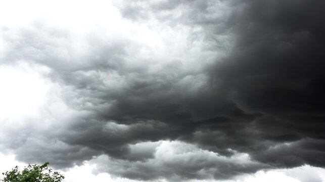 A moody, stormy sky filled with dark, swirling clouds, creating an intense and dramatic atmosphere as a storm approaches - Powered by Adobe