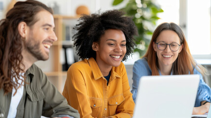 diverse group of coworkers happily collaborating on project in modern office setting