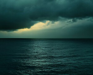 Dramatic ocean scene with dark clouds and a sliver of light.