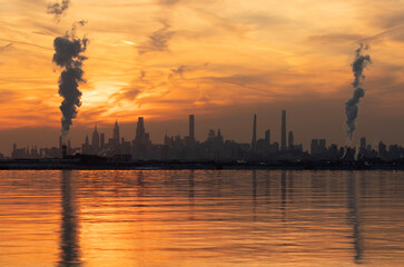 Smoke stack rising above the Manhattan skyline in New York City	
