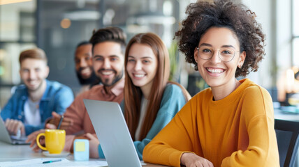 diverse group of young professionals smiling and collaborating in modern office setting, showcasing teamwork and creativity