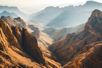Fototapeta premium View from above of rugged desert mountains bathed in golden sunlight, the shallow depth of field enhancing the sharpness of the jagged cliffs and gentle slopes.
