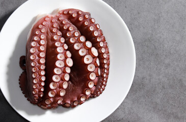 Octopus on a white plate. Fresh seafood steamed dish.
