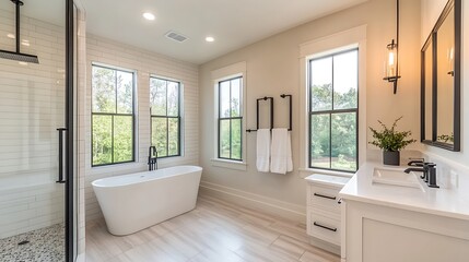 Fototapeta premium A stylish modern bathroom featuring a freestanding tub and large windows for natural light.