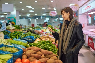 Young Woman Choosing Vegetables at a Local Market Healthy Eating Concep