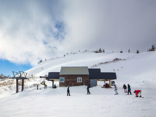 Chairlift unloading point at the top of the ski resort with thick clouds (Kawaba, Gunma, Japan)