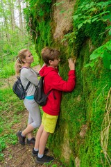 Young family travels among large rocks in the rocks