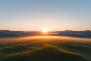 Vibrant sunrise casting golden hues over rolling hills and misty
