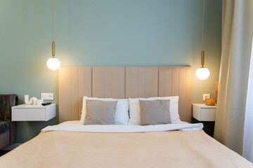 Step into a Modern and Cozy Bedroom featuring Elegant Lighting and Soft Textiles that create a tranquil and calming ambiance for relaxation