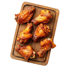 Delicious roasted chicken wings on wooden board appetizing food