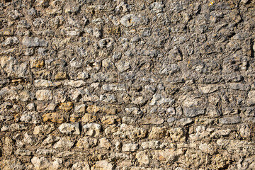 semantically made stone background old weathered rough stones cobbled wall with cracks