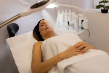 Relaxation and rejuvenation during a soothing facial treatment at a tranquil spa environment in the early afternoon
