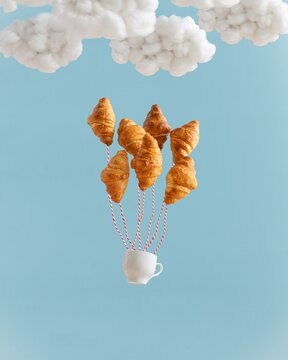 Croissant Balloon Flight. Сonceptual creative breakfast