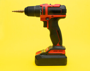 Cordless screwdriver with a drill for metal on a yellow background.