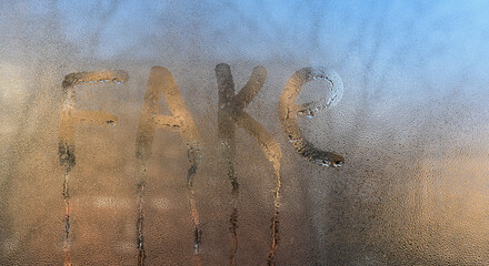 the word fake is written on the glass.