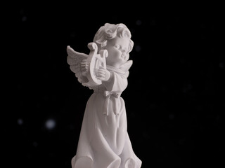 A white angel statue holding a harp