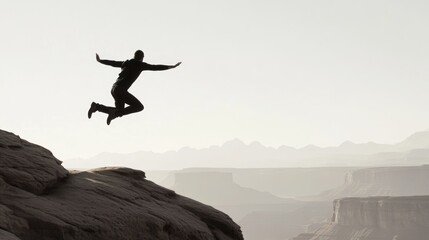 Silhouette of Adventurer Jumping Across Rocks in Mountainous Landscape