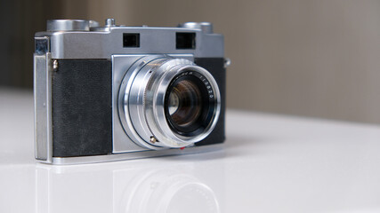 A vintage film camera is waiting for you on the table. When will you start taking pictures