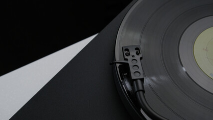 A vinyl record spinning on a turntable, creating music for the atmosphere