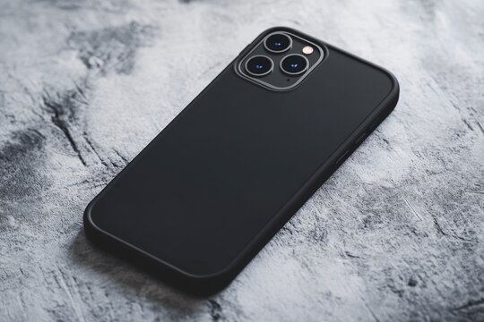Black Smartphone with Case on Textured Surface Background