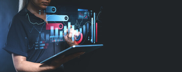 Woman analyzing digital charts and graphs using a tablet.