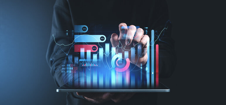 Interactive financial charts and graphs displayed on a tablet device in a dark setting.