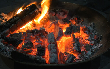 Picture of coals burning in a fireplace during winters in home.