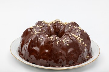 Delicious bundt cake with marbled chocolate glaze, topped with chopped nuts. Perfect for food photography, dessert concepts, and culinary presentations