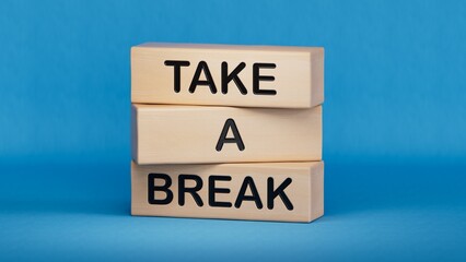 Take a break symbol. Concept words Take a break on wooden blocks.Business and Take a break concept. Copy space.3D rendering on blue background.