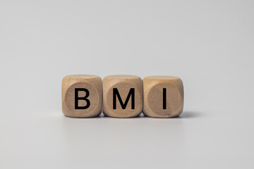 The word BMI written on a cube on white background. Medical concept.