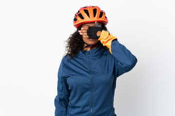 Teenager cyclist woman isolated on white background covering eyes by hands. Do not want to see something