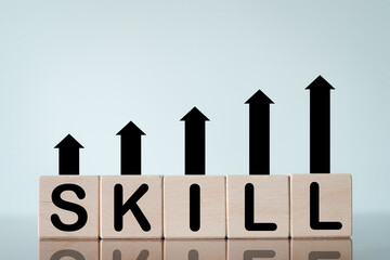 Wooden cubes spelling "SKILL" with an upward chart, ideal for growth, development,self-improvement,Upskill,Re-skilling,training,continuous learning.