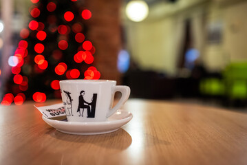 Cozy Coffee Moments with Festive Christmas Lights and Artistic Ceramic Cup - Warm Holiday Vibes in a Modern Café Setting