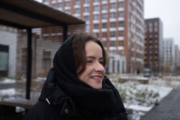 Portrait of a teenage girl on a city street, joyful lifestyle of a teen outside, urban architecture and relaxed day walk.