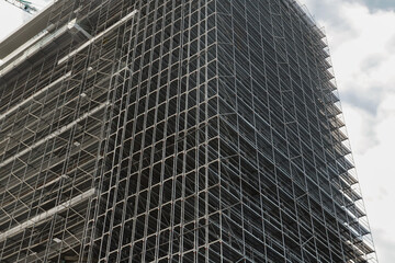 Metal Scaffolding on Building Facade, renovation project, building materials, scaffolding layers