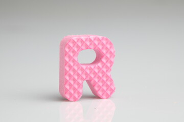R in pink colour foam