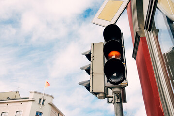 Red traffic light for pedestrians, semaphore background foggy autumn sky