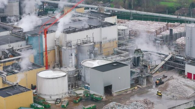 industrial plant factory oudegem belgium featured recycling site reveals steam rising machines working close up aerial drone panning shot view vpk packaging group 