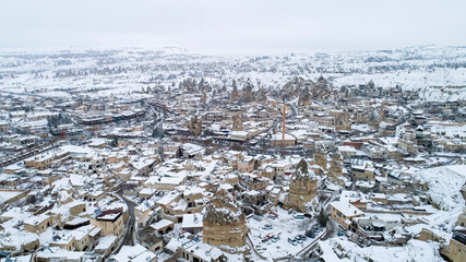 Cappadocia, Goreme view under snow. Aerial shot of the city center with a drone. Cappadocia, Turkey.