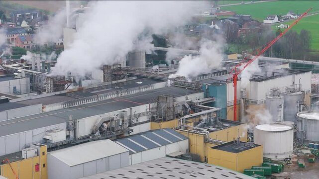 industrial plant factory oudegem belgium steam industry recycling paper operational close up backward aerial drone shot view vpk packaging group 