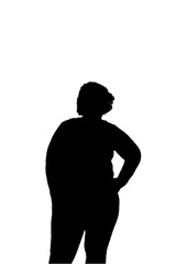 A woman is standing in front of a white background. She is wearing a black shirt and black pants