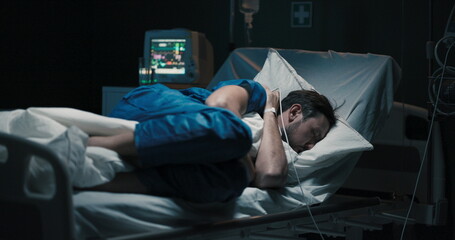 Fototapeta premium Tired patient in hospital bed can't sleeps.