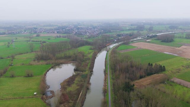 river dender depicted belgian countryside during misty foggy morning green fields serene natural forward aerial drone shot belgium view scenic overview 