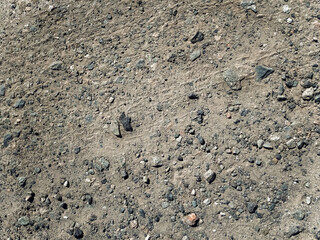 Pieces of old concrete, slag and gravel in the form of small gray stones, view from above. Old road...