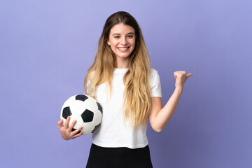 Young blonde football player woman isolated on purple background pointing to the side to present a product