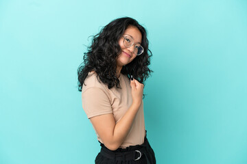 Young asian woman isolated on blue background proud and self-satisfied