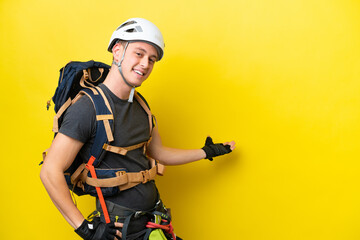 Young rock climber Brazilian man extending hands to the side for inviting to come