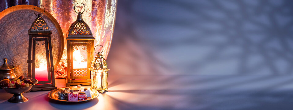Iftar fast-breaking evening meal of Muslims in Ramadan at the time of adhan. Arabic lantern for Muslim holy month Ramazan Kareem. Decorative Holiday lamp